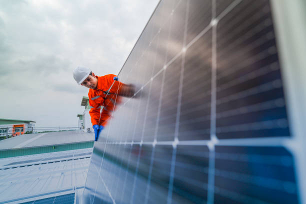 istock engineer man inspects construction of solar cell panel or photovoltaic cell by electronic device. Industrial Renewable energy of green power. factory worker working on tower roof. 2173005359