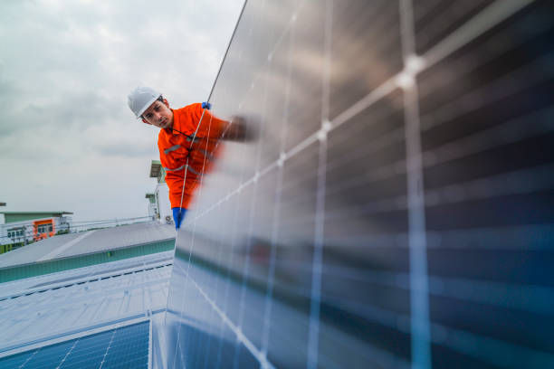 istock engineer man inspects construction of solar cell panel or photovoltaic cell by electronic device. Industrial Renewable energy of green power. factory worker working on tower roof. 2173005679