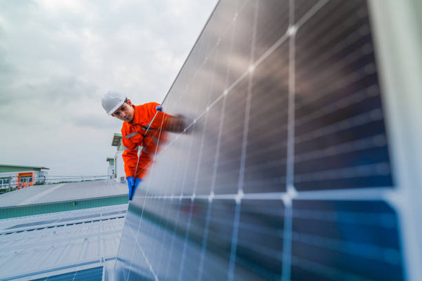istock engineer man inspects construction of solar cell panel or photovoltaic cell by electronic device. Industrial Renewable energy of green power. factory worker working on tower roof. 2173006495