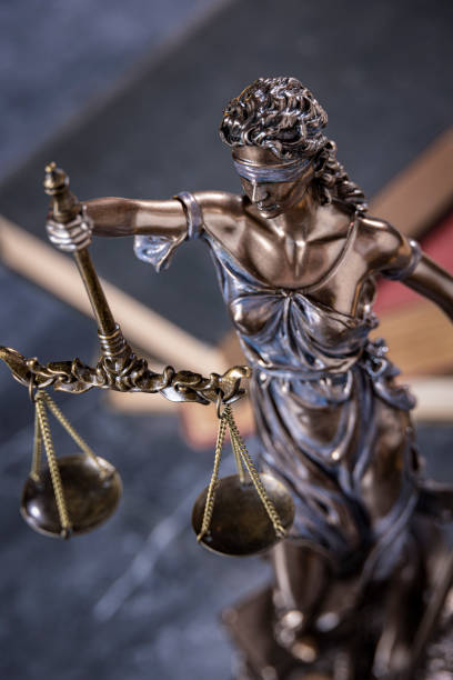 istock Lady Justice with books in the background on gray marble 2173009383