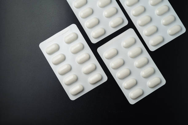 istock Tablet pills blister Medicine capsules on a black background 2173013709