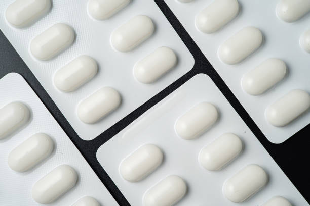Tablet pills blister Medicine capsules on a black background