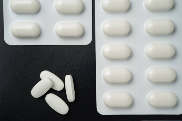 istock Pills Medicine tablet capsules in blister pack on a black background 2173014212