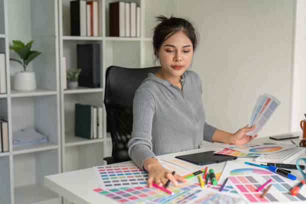 istock Graphic designer analyzing color swatches at desk 2173022493