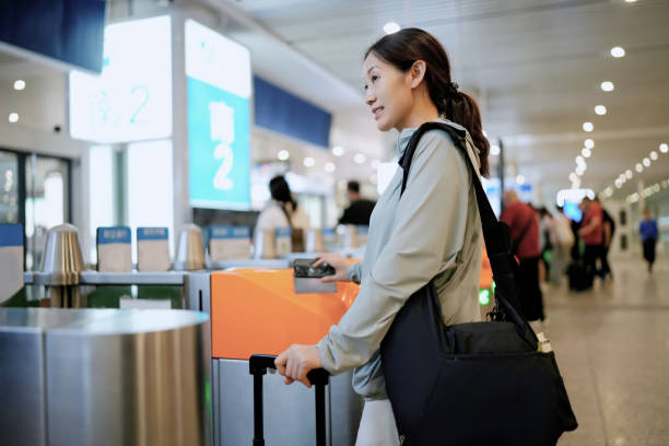istock Young Woman Navigating Airport Checkpoint with Luggage 2173025486