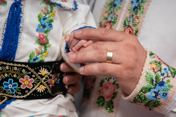 istock A man dressed in folk costume holding baby's hand, 2173025554