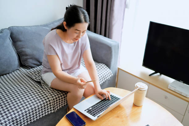 istock Engaging in Remote Work: A Woman's Focused Moment at Home 2173027357