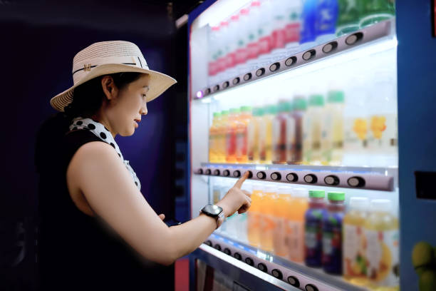 istock A Woman Selecting Refreshing Beverages from a Vending Machine 2173031148