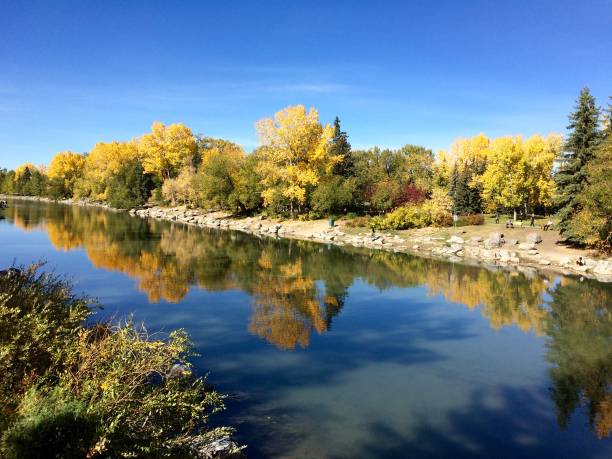istock Natural Transformation. Autumn fall colours landscape with reflection in river water 2173044041