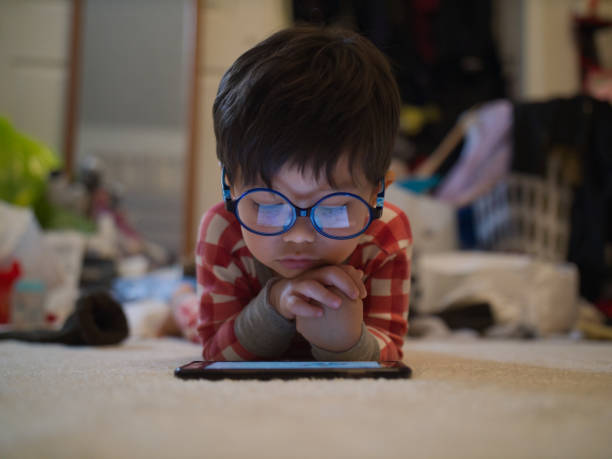 boy toddler viewing cartoons on smartphone