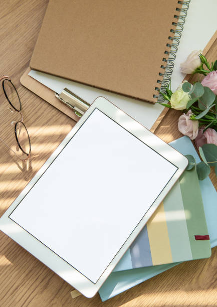 istock A cozy workspace setup featuring a tablet, stationery, and fresh flowers in soft natural light for inspiration and creativity 2173045357