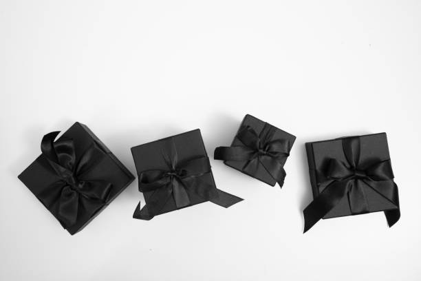 istock Black Friday Sale. Black gift boxes with ribbon bow isolated on white, top view 2173046714