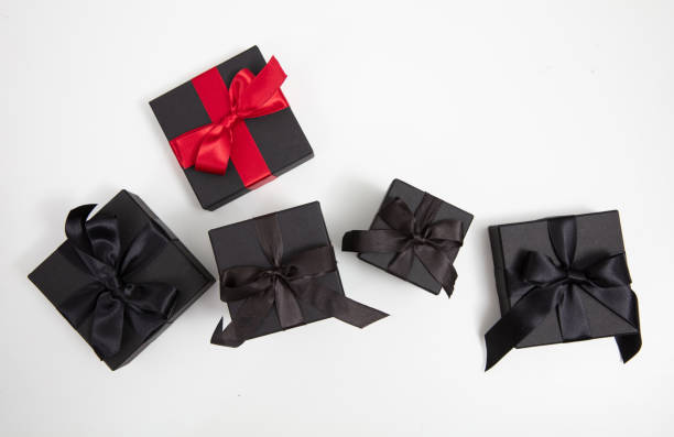 istock Black Friday Sale. Black gift boxes with ribbon bow isolated on white, top view 2173046724