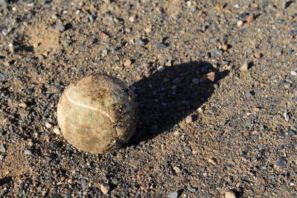 Yellow tennis ball on a hard court
