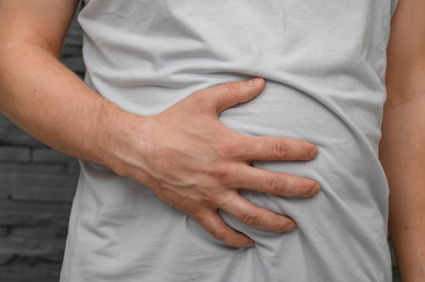 istock Man holding his fat belly, bloating 2173059253