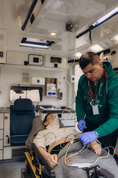 istock Paramedic using oxygen mask to help unconscious woman 2173059391