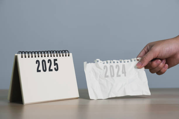 istock Man's hand pulling a calendar 2024 to 2025. year change from 2024 to 2025. Setup objective target business cost and budget planning of new year concept. 2173061165