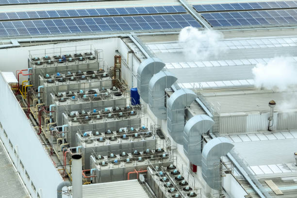 istock Sustainable industrial rooftop. Aerial view showcasing solar panels, ventilation systems, and industrial chillers. Renewable energy and efficient cooling in modern manufacturing facilities. 2173061632