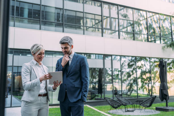 istock Business people using digital tablet outdoors. 2173062802