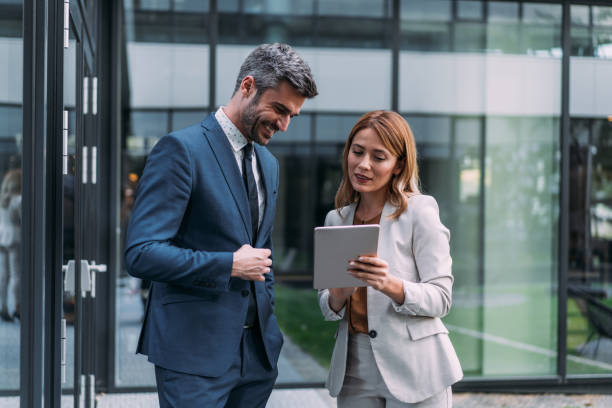 istock Business people using digital tablet outdoors. 2173062833