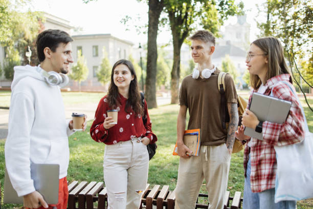 istock Cheerful Group of Students Engaged in Conversation During University Break 2173063352