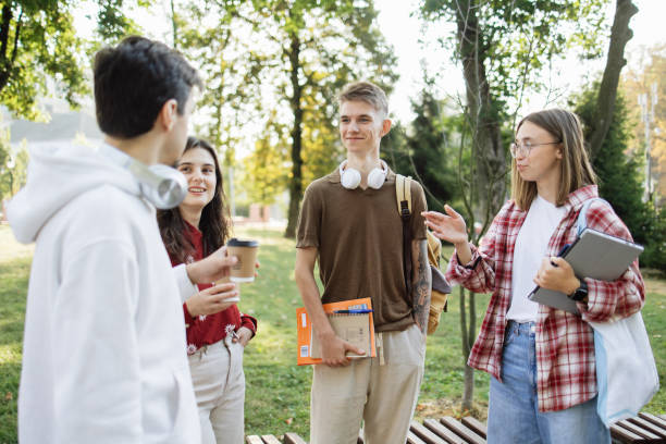istock Cheerful Group of Students Engaged in Conversation During University Break 2173063389
