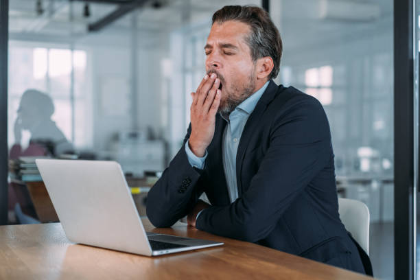 istock Exhausted businessman using laptop in the office. 2173063513