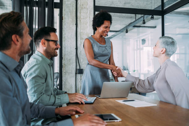 istock Businesswomen shaking hands across the table. 2173063810