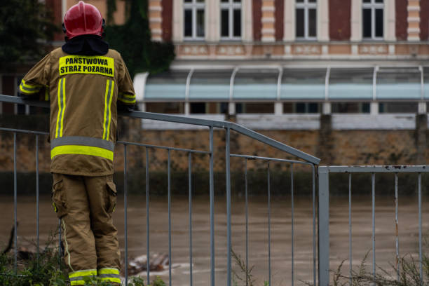 istock A firefighter (Pastwowa Stra Poarna) looking at Odra river in Opole and its water level caused by flood 2173064103
