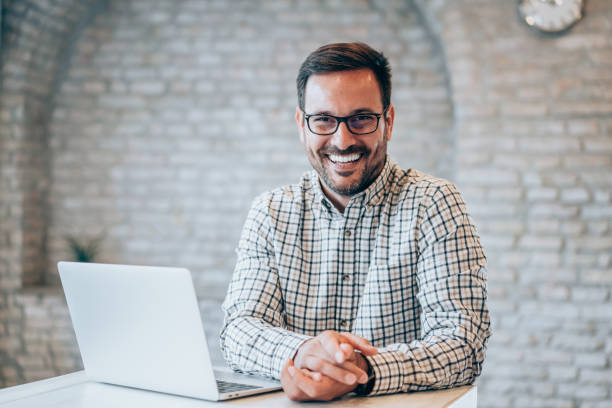 istock Successful businessman in modern office working on laptop. 2173065083
