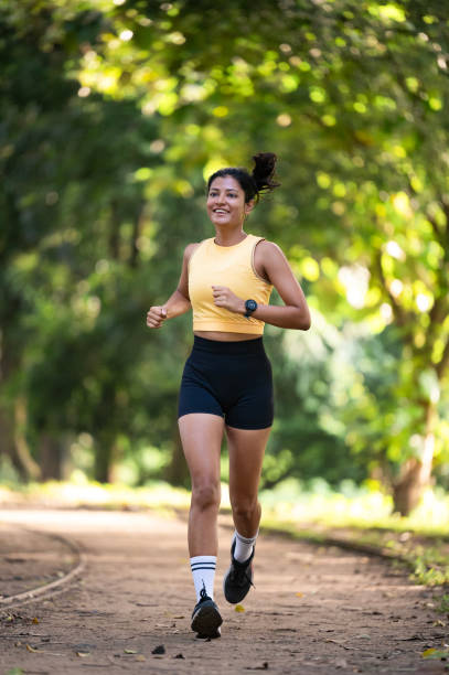 istock Happy female athlete running in the park. 2173065577