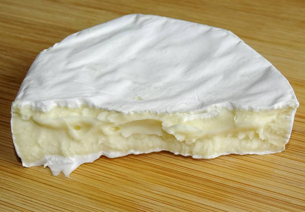 istock Camembert cheese on wooden background 2173067020