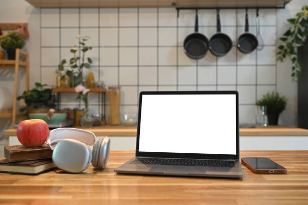 istock Front view laptop with blank screen on a wooden kitchen counter 2173068647