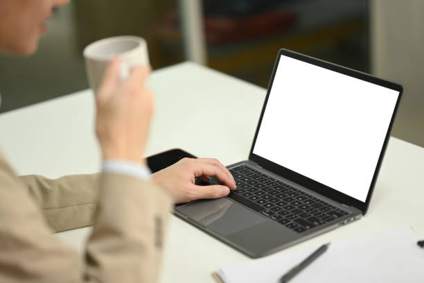 istock Professional businessman drinking hot coffee and using laptop on office desk 2173068719