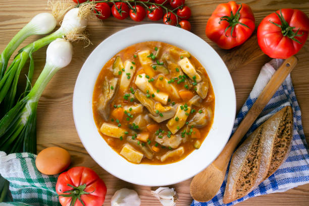 istock Squid stew with potatoes, artichokes and vegetables. Top view table with decoration. 2173068760