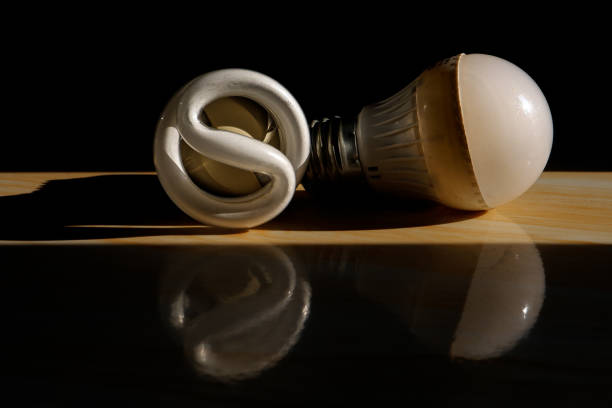 A compact fluorescent lamp (CFL) is lying on the floor, a spiral fluorescent lamp.