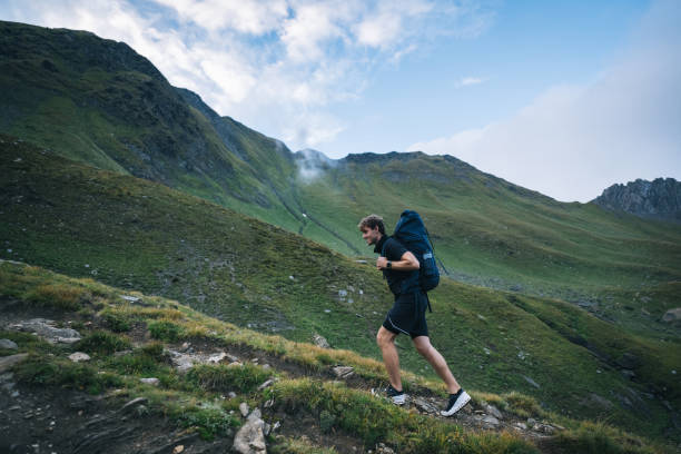 istock Backpacker hikes mountain ridge on moody day 2173071502