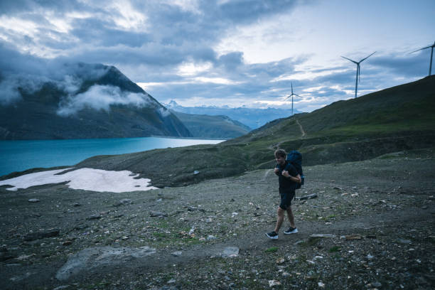 istock Backpacker hikes above lake and mountains 2173071656