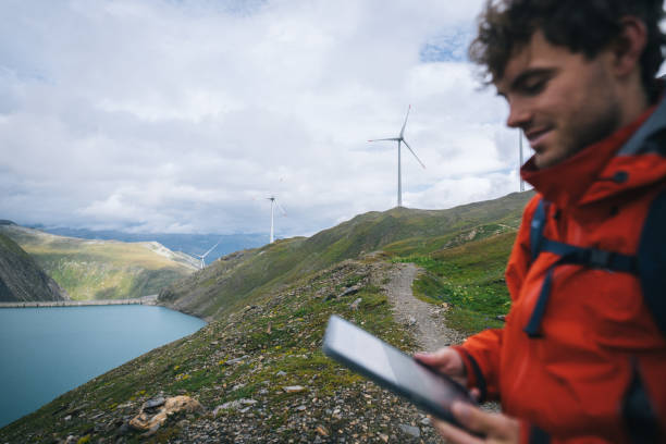 istock Backpacker uses digital tablet above alpine lake 2173073225