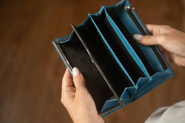 istock Woman revealing an empty wallet and highlighting financial struggles 2173074538