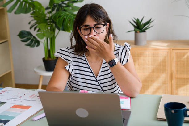 istock Tired businesswoman yawning while working from home office 2173076005