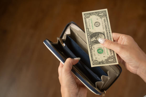 istock Woman taking out one dollar from her wallet 2173076059