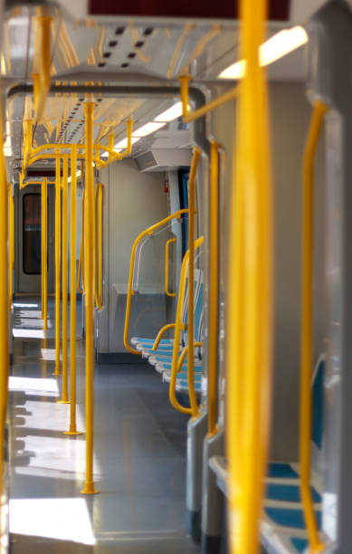 istock An empty modern train interior, with bright yellow handrails and clean design 2173080102
