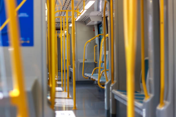 istock Empty modern subway train interior with yellow handrails and blue seating 2173080105