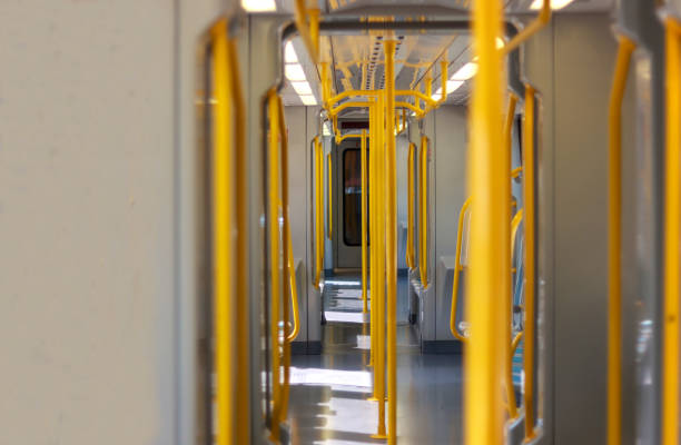 istock An empty modern train interior, with bright yellow handrails and clean design 2173080113