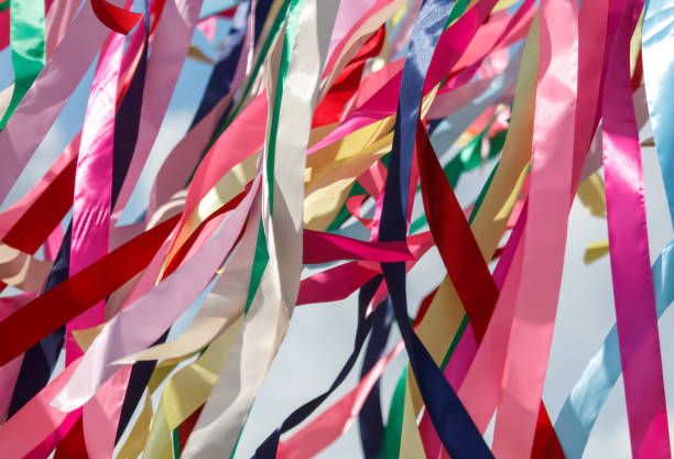 istock Multicolored festival ribbons flutter in the wind. Background 2173080475