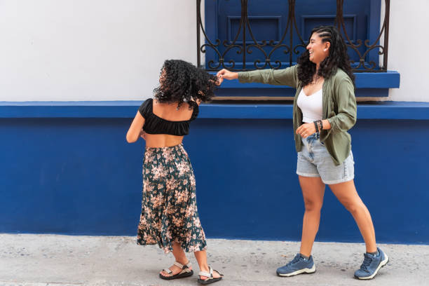 istock Two playful women outdoors, one pulling the other's curly hair 2173081869