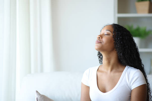 istock Black woman relaxing breathing fresh air on a sofa 2173082096