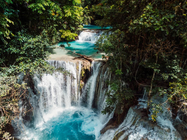 istock Scenic cascade waterfall with natural blue water in Central Sulawesi, drone view 2173082325