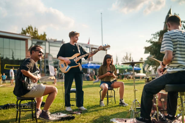 istock Music group tuning their instruments while rehearsing outdoors 2173084810